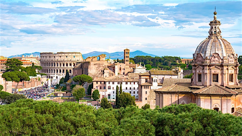Colosseum and historic Roman Forum skyline with iconic landmarks, Rome, Italy.
