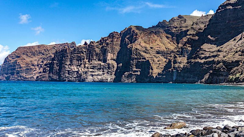 Towering Los Gigantes cliffs rise above clear blue waters on Tenerife’s coast, showcasing dramatic scenery for memorable Value holidays.