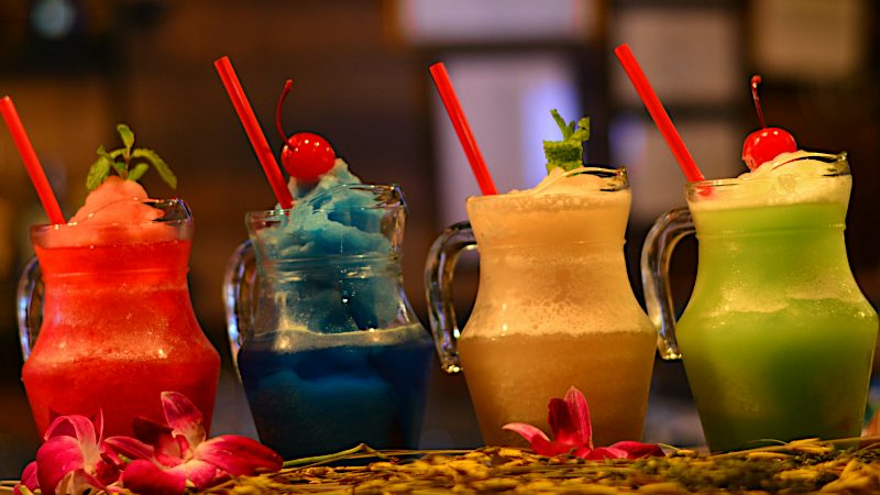 Colourful frozen cocktails lined up at a Tenerife bar capture the lively evening atmosphere enjoyed on Value holidays.