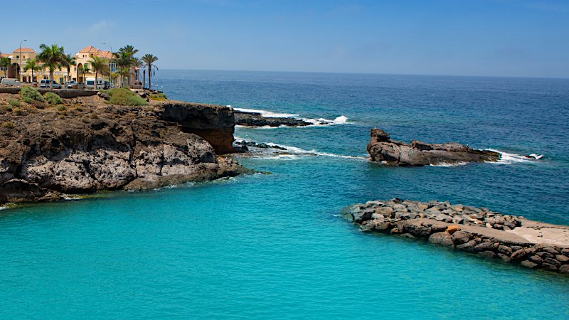 Clear turquoise waters and rocky coves at Playa Paraiso create a tranquil coastal escape for Tenerife Value holidays.