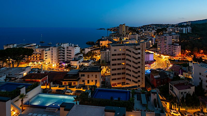 Mallorca coastal resort skyline at night with illuminated hotels, waterfront views and city lights.