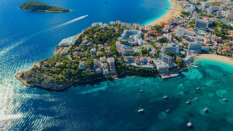 Aerial view of Palma Nova coastline with turquoise bays, beachfront resorts and Mediterranean waters.